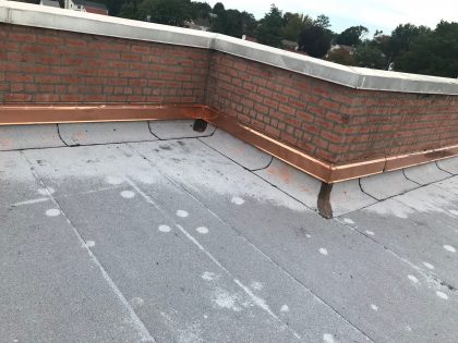 What Should Property Owners Know About Parapet Wall Damage and Roof Replacements?