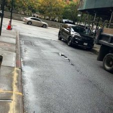 Curb edge and street next to the completed sidewalk section in East Village