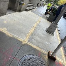 Newly poured slabs with crew working further down the block