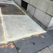New concrete slab beside older dark slabs near a building wall