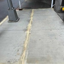 New concrete slabs with a sand-filled joint under scaffolding